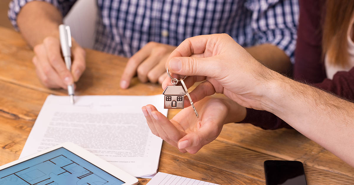 Close up hands receiving house keys